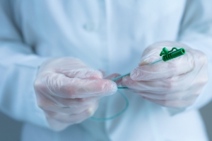 Close up of a catheter in gloved hands